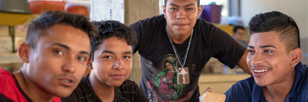Image shows four young men from a refugee shelter in Southern Mexico.